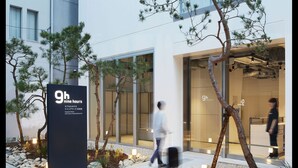 A modern hotel entrance with a sign indicating '9h nine hours' service. - 9h nine hours Hamamatsucho (Tokyo)