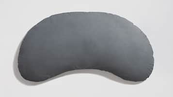 A gray, curved pillow against a white background.