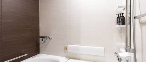 A modern bathroom with a bathtub, shower, and vanity.
