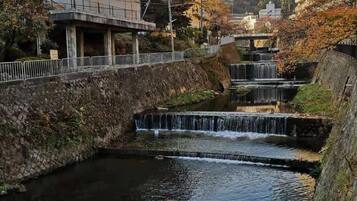 A small river with a bridge and buildings in the background.