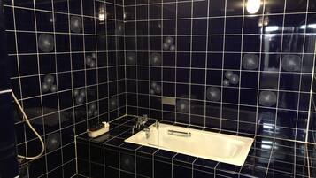 Separate bathtub and shower, free toiletries, hair dryer, slippers