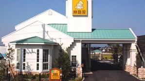 A building with a green roof and a sign featuring a bear.