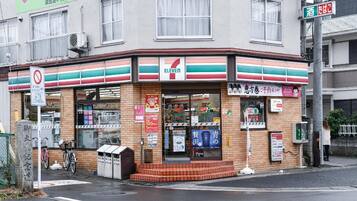 A 7-Eleven convenience store with a brick facade, large windows, and a visible entrance.