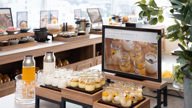 Un buffet de petit-déjeuner proposant une variété d’aliments et un présentoir affichant le menu.