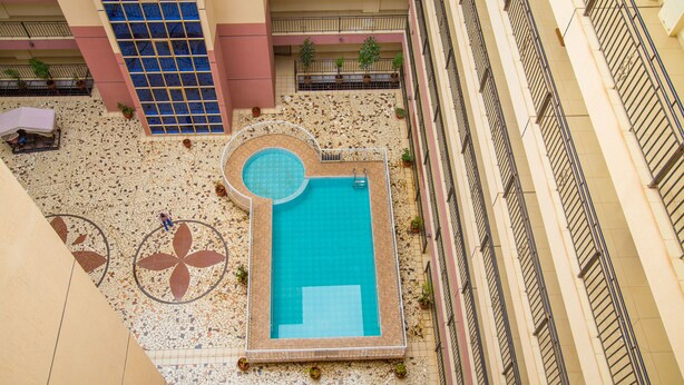 A rooftop pool area with a small pool, a circular seating area, and potted plants. - Nairobi Luxury Suites (Nairobi)