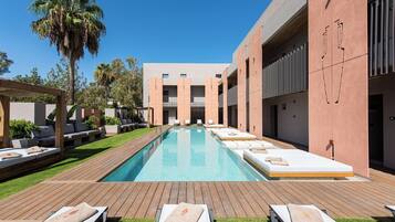 Piscine extérieure, parasols de plage, chaises longues