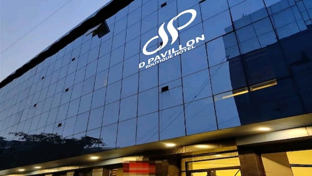 A modern building with a reflective glass facade and the logo "D Pavilion Boutique Hotel" prominently displayed. - The Vegas By De Pavilion, Delhi Airport (New Delhi)
