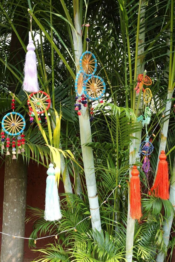 A tree adorned with colorful dreamcatchers and tassels.
