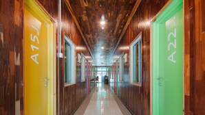 A hallway with wooden walls and doors labeled A15J and A22J. - Mabohai Resort Klebang (Malacca City)