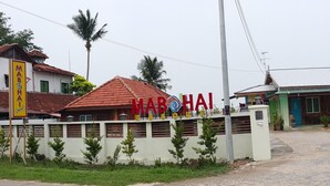 A hotel named 'MABOHAI RESORT' with a red roof and white walls, surrounded by greenery and palm trees. - Mabohai Resort Klebang (Malacca City)