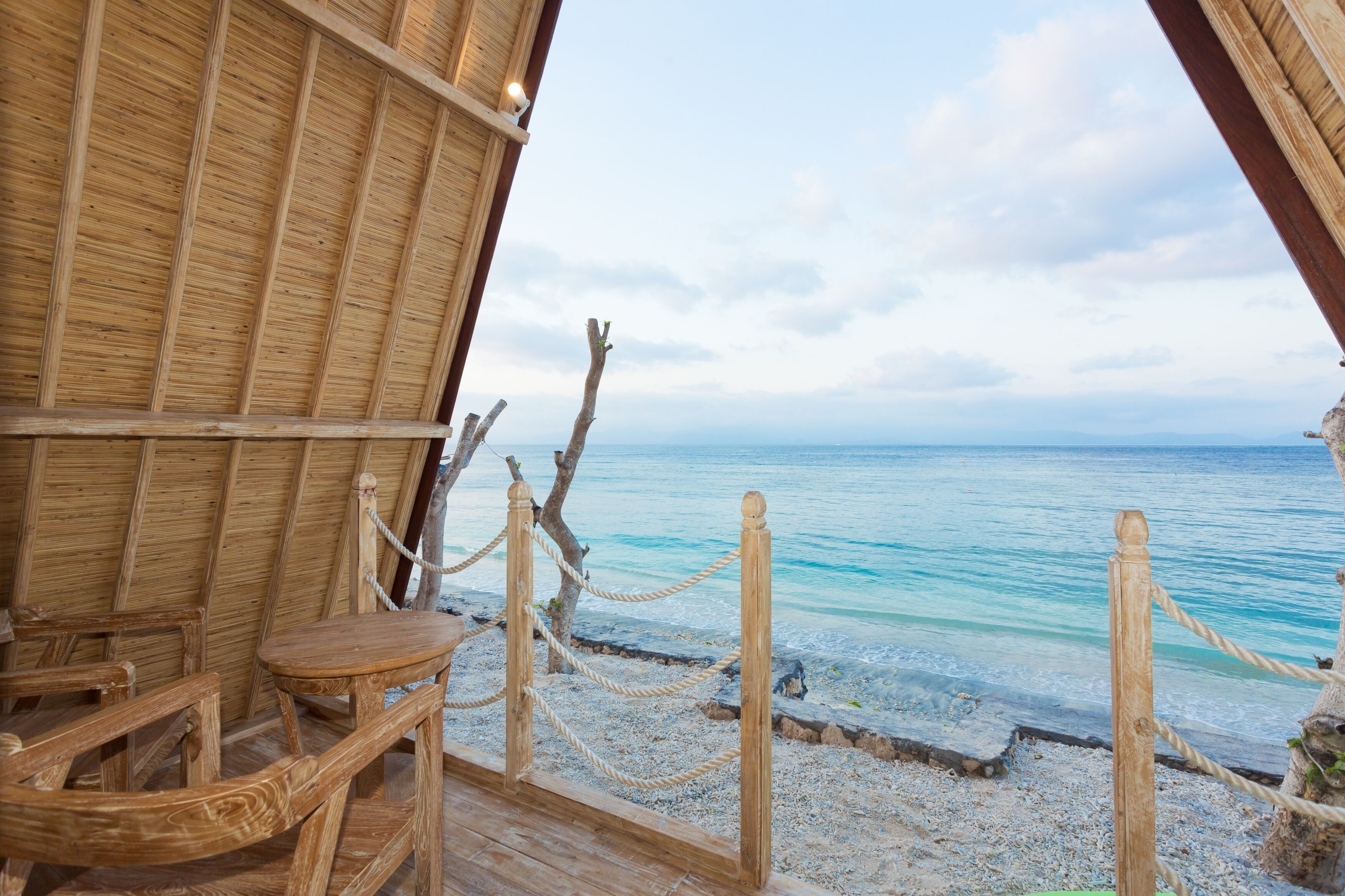 A wooden deck with a view of the ocean.