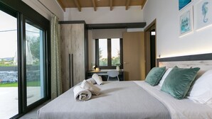 Quarto com cama grande, escrivaninha e vista para o exterior.