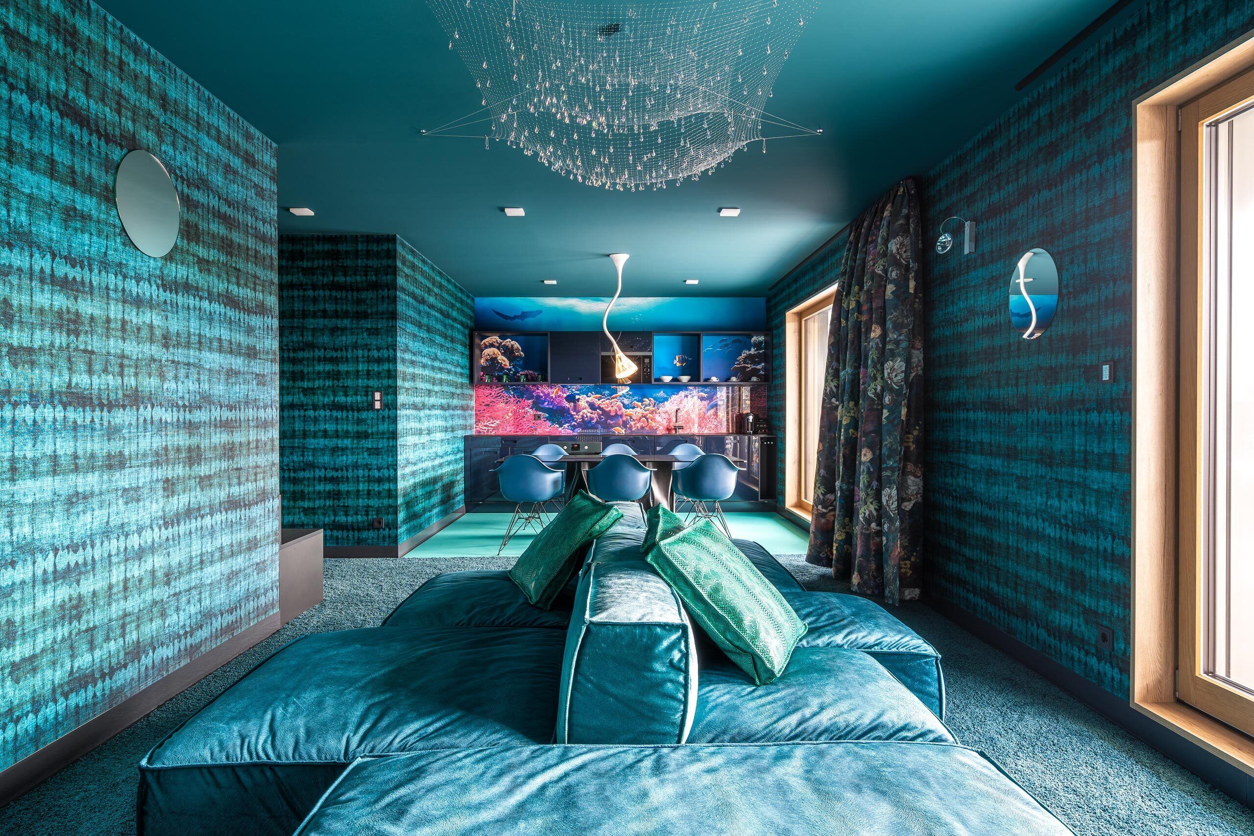 A room with a large bed, a ceiling light, and a view of a bar area.