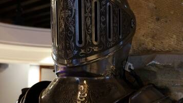 A close-up of a knight's helmet with intricate engravings.