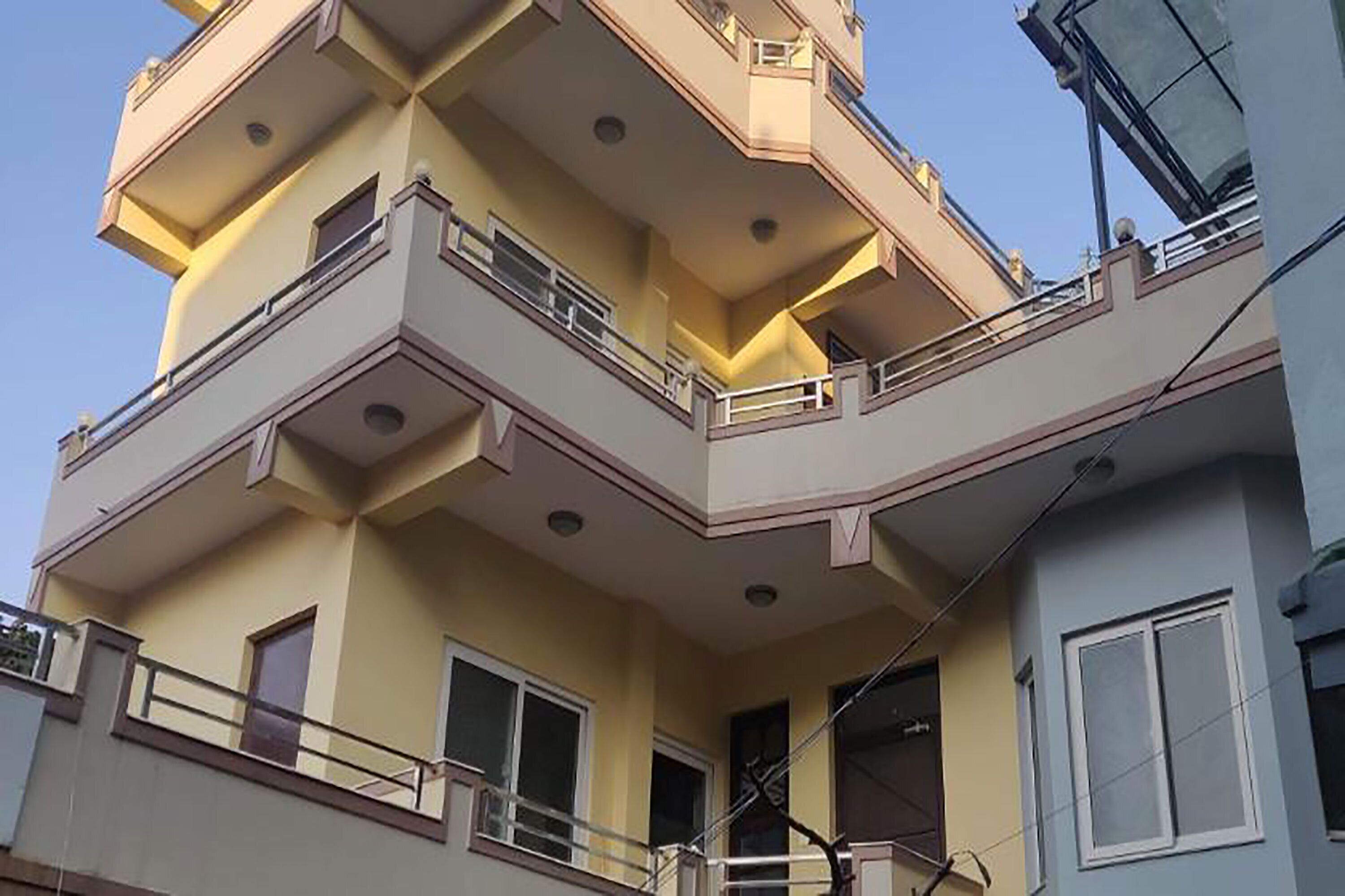 A multi-story building with balconies and windows.