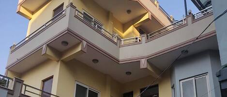 A multi-story building with balconies and windows.
