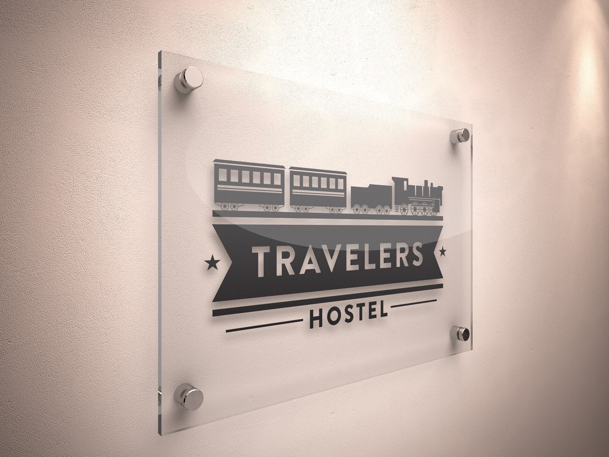 A sign with a train and the words "TRAVELERS HOSTEL" on a wall.