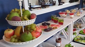 A buffet table with a variety of fruits, desserts, and a tray of eggs. - Monte Carlo Boutique Hotel (Swinoujscie)