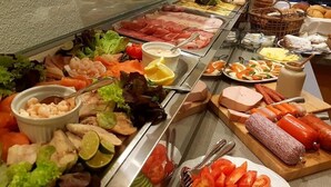 A buffet with various food items including meats, seafood, and vegetables. - Venngasthof Zur Buche (Monschau)