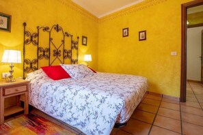 A bedroom with a bed, two bedside tables, and a nightstand. - Apartamento Vulcano - Two Bedroom Apartment, Sleeps 3 (Adeje)
