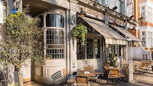 A corner building with a sign reading 'THE CHAMPION' and outdoor seating. - The Brunswick Oasis 2 bedroom in Notting Hill (London)