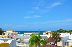 A coastal view with buildings and a clear blue sky.