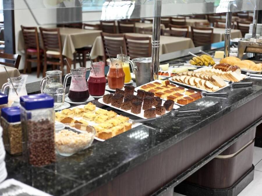 A buffet with various food items and beverages.