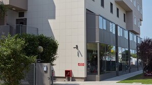 A modern hotel building with a prominent 'DC Hotel' sign, large windows, and a clean, contemporary design. - DC Hotel International (Padova)