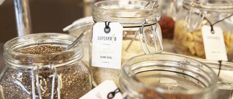 A display of glass jars with labels, likely containing various seeds or grains.