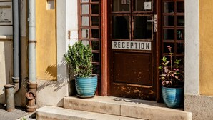 A building with a reception area, a signboard, and two potted plants. - BlueBell Hotel (Bratislava)