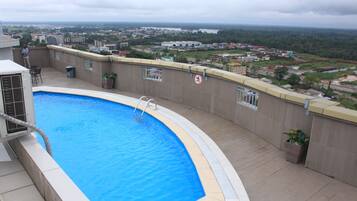 Relax by the rooftop pool with a stunning city view.