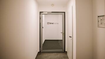 A hallway with a door labeled "limehome" leading to a room.