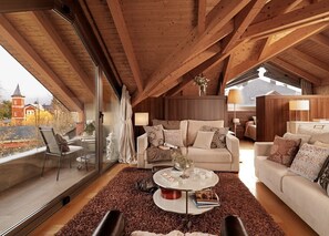 A cozy loft-style room with a high ceiling, wooden beams, a large window with a view of a red building, a beige sofa, a coffee table, and a small side table.