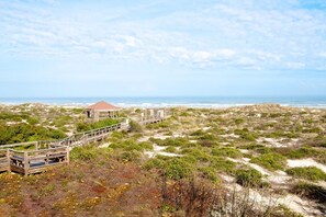 A coastal area with a wooden boardwalk leading to a gazebo-like structure. - Shell Shack - St. Augustine Beachside Resort Condo (St. Augustine)