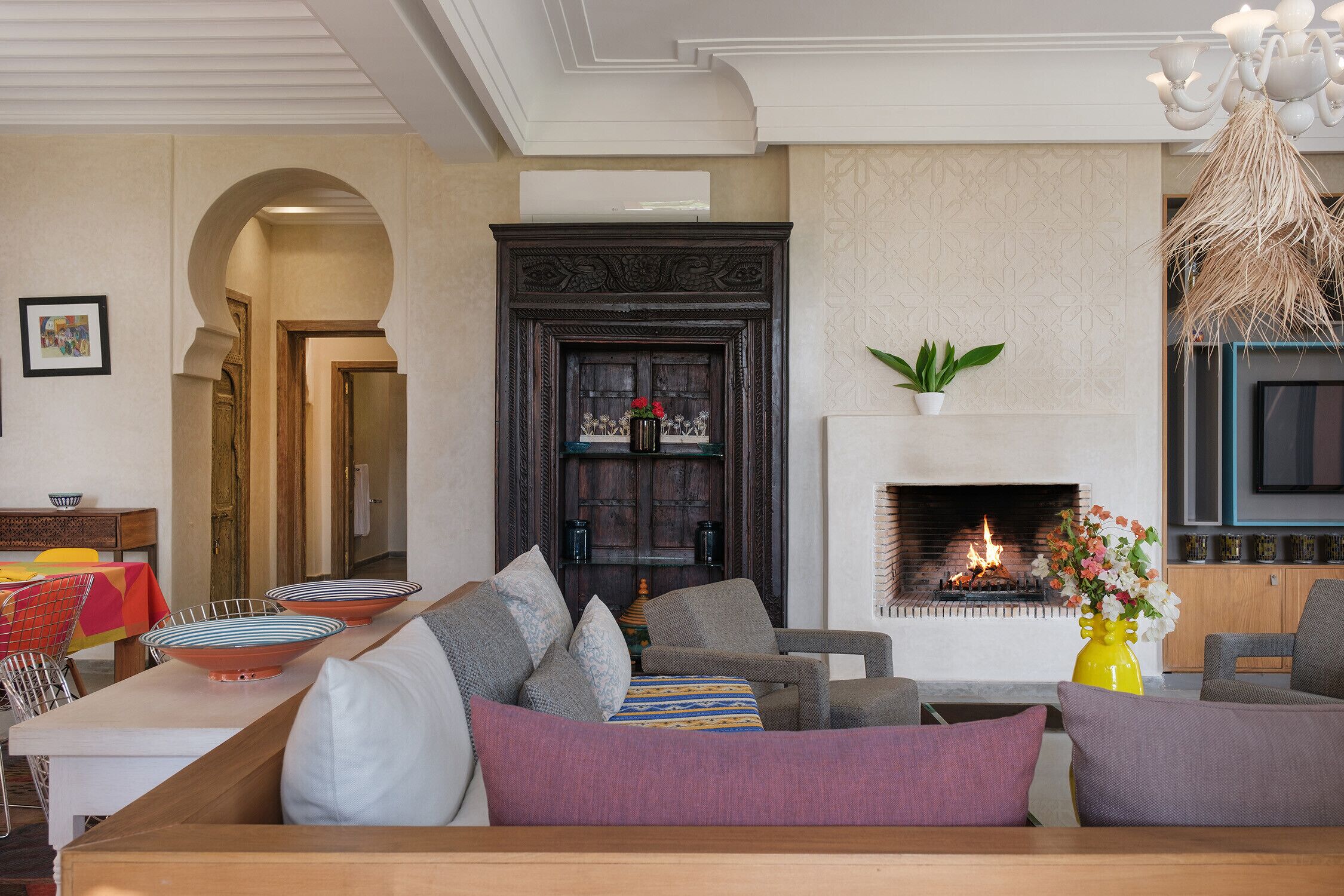 A living room with a fireplace, sofas, and a coffee table.