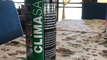 Une bombe de Climasan posée sur une nappe à motifs floraux.
