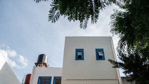 A building with a white facade and blue window frames.