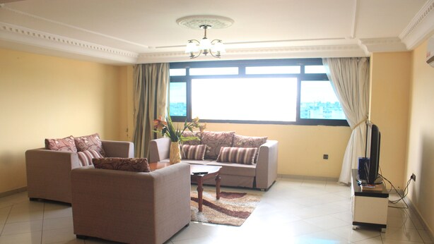 A living room with two sofas, a coffee table, and a TV stand.