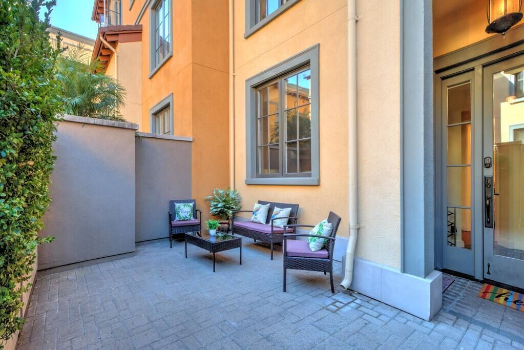 A patio with outdoor furniture and a large window.