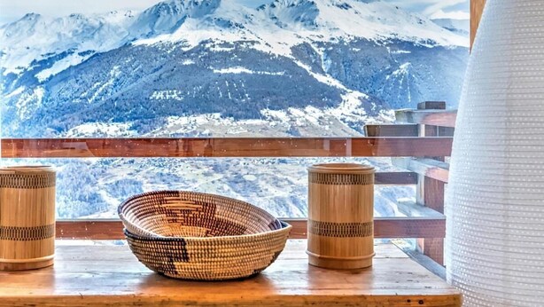 A wooden table with a woven basket and two cylindrical containers, overlooking a snow-covered mountain range. - Chalet, wifi, ski-in/ski-out & foot of the slopes, sauna, terrace, balcony, fireplace or stove (Les Collons)