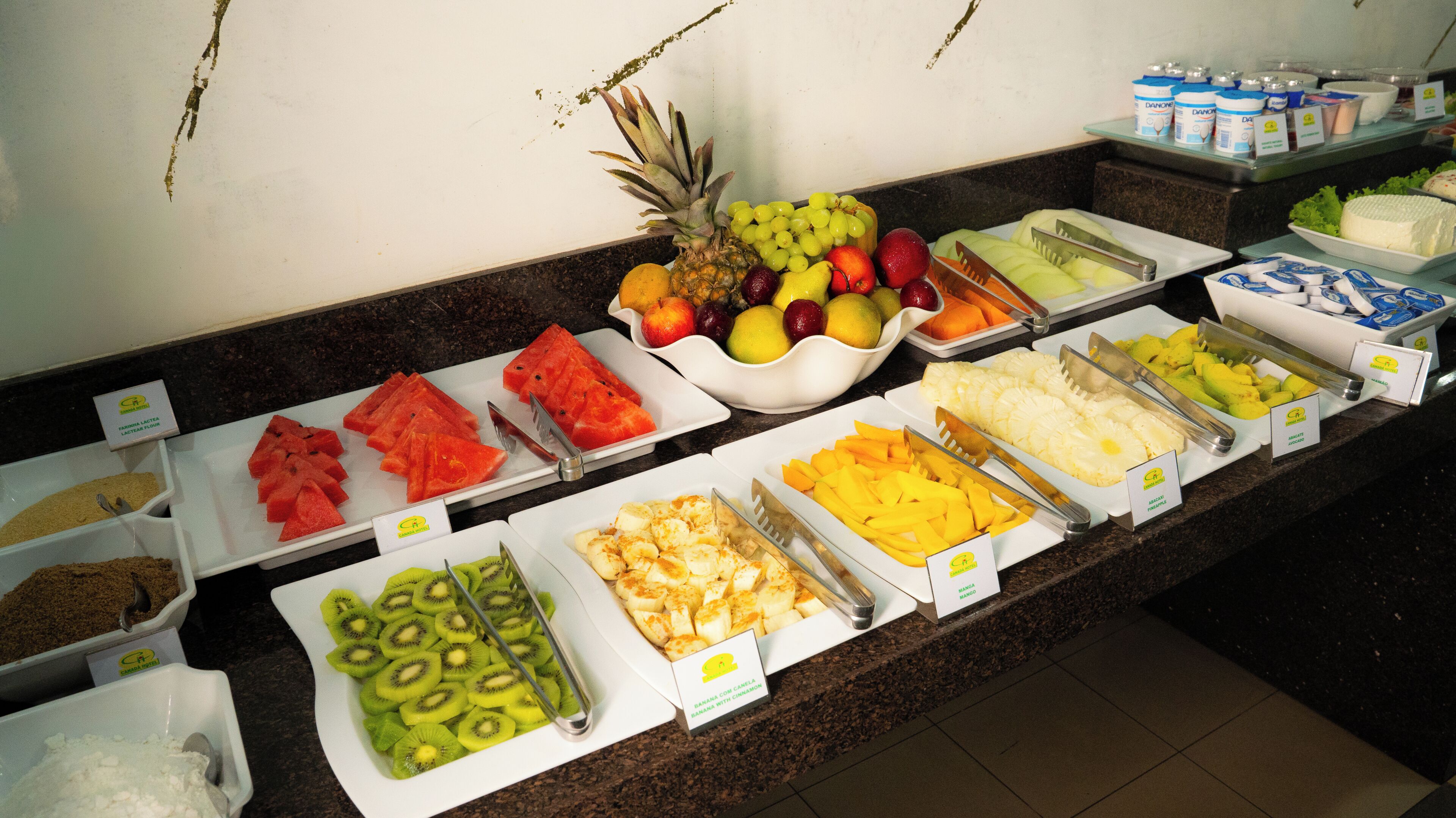 A buffet with various fruits and dairy products.