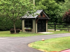 retreat surrounded by lush greenery and a secure wooden fence.