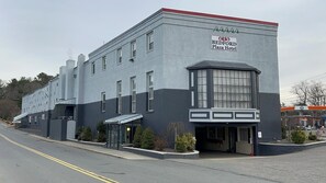 A two-story building with a sign for Bedford Plaza Hotel. - Bedford plaza hotel (Bedford)