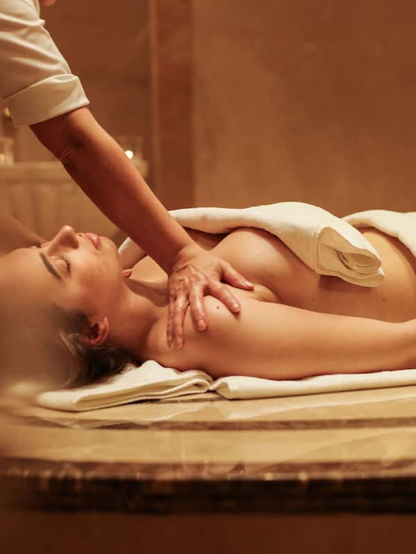 Experience a rejuvenating massage on a comfortable table with expert care.