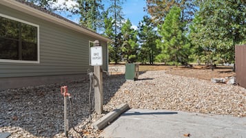 A building with a 'BIKE WASH' sign, gravel driveway, and trees in the background.