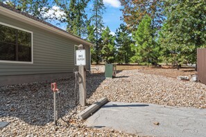 A building with a 'BIKE WASH' sign, gravel driveway, and trees in the background.