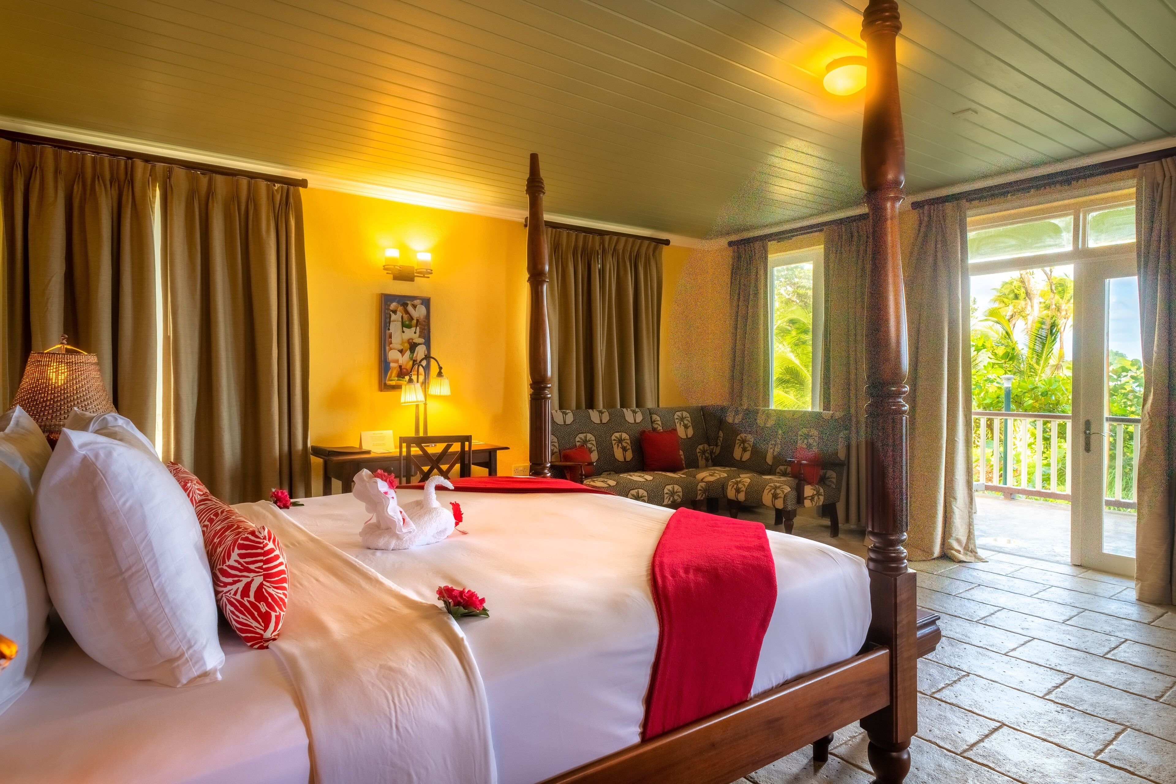 Una habitación de hotel con una cama grande, un balcón y vistas a zonas verdes.