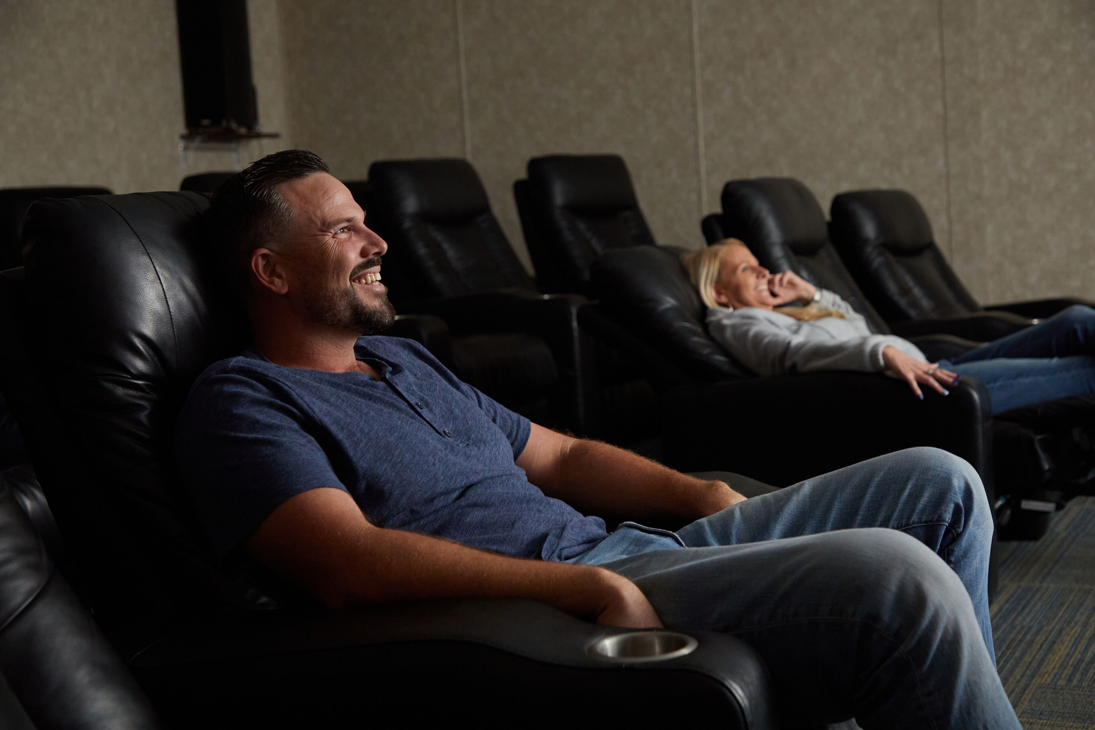 A massage therapy room with leather reclining chairs and a metal tray on one of them.