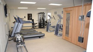 A fitness center with treadmills, elliptical machines, and weight machines. - Target Hospitality-Williams County Lodge (Williston)