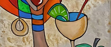 Un tableau représentant une femme tenant une boisson avec une paille et un fruit.